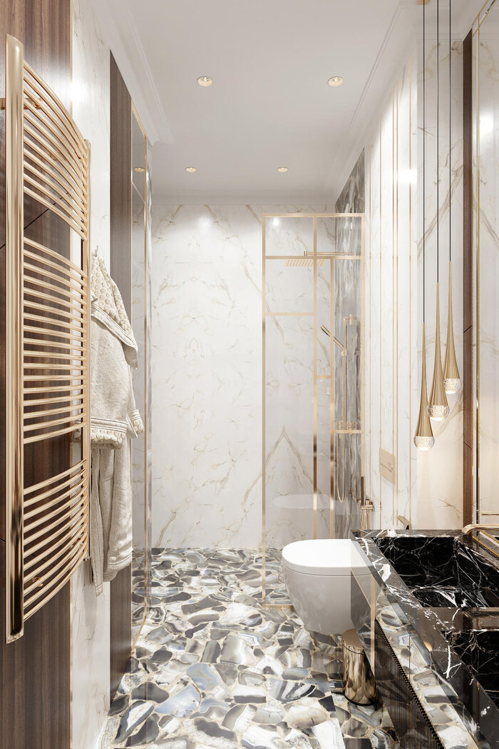 Полотенцесушитель золотого цвета в интерьере ванной